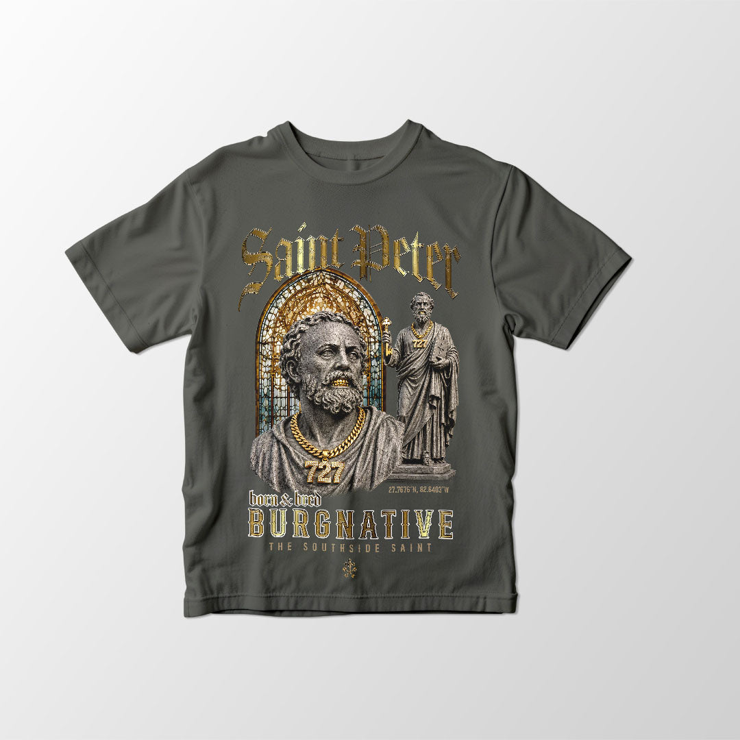 A dark gray crewneck t-shirt featuring a detailed graphic print of Saint Peter with gold lettering and a cathedral arch design, displayed flat against a light gray background.